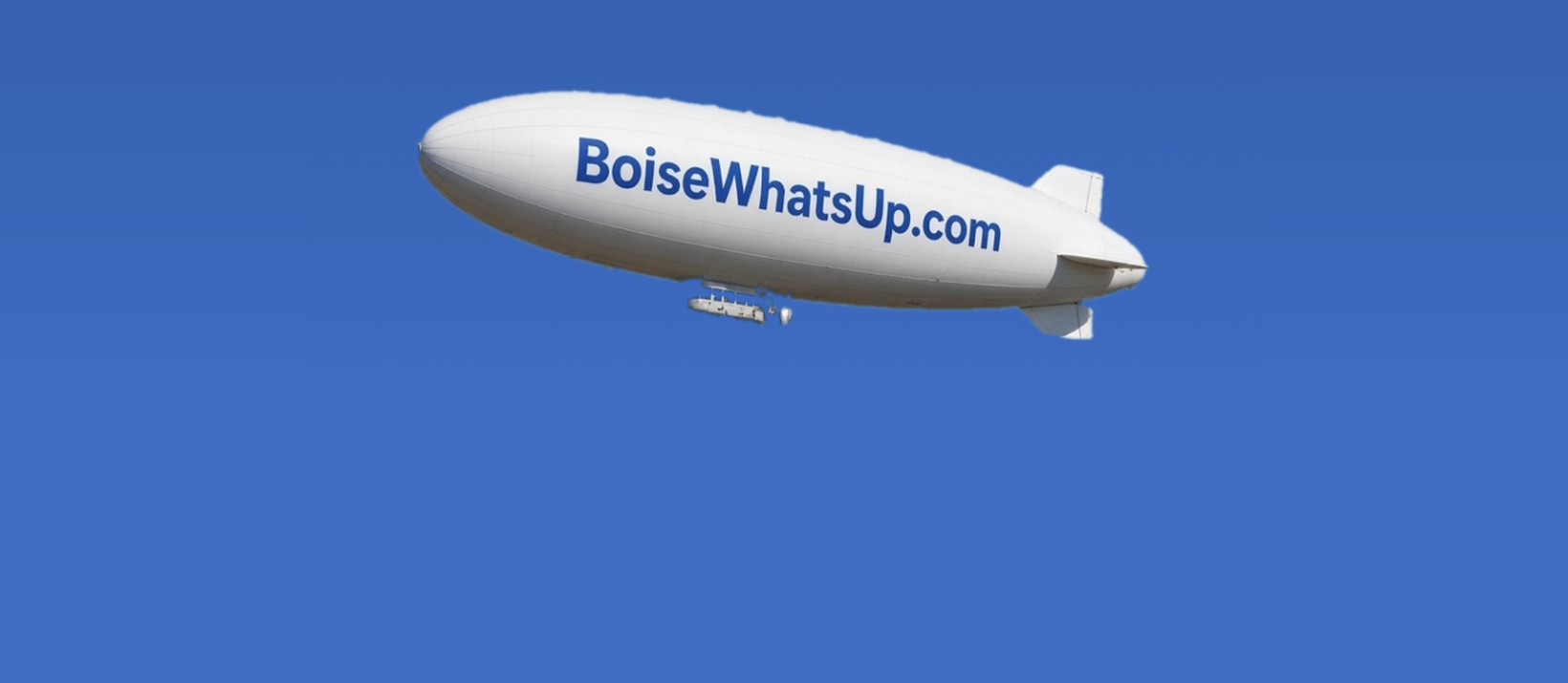 The BoiseWhatsUp.com blimp on a blue sky
